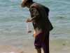 old woman collectin crabs in koh samui