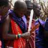 masai warrior prepares to start a fire in Ngorongoro